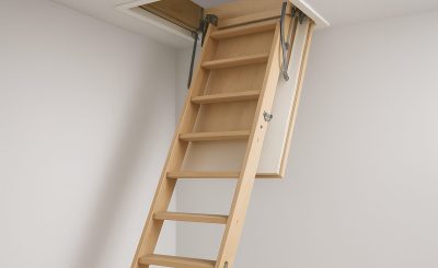 A wooden loft ladder extending from a ceiling hatch, demonstrating a home safety feature.